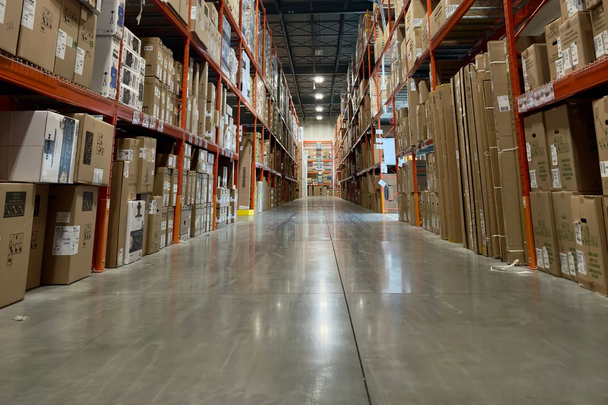 Long aisle inside a distribution warehouse, one of five hubs on a single compressed air contract