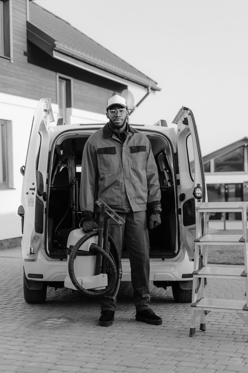 Service engineer at the back of his van with equipment, ready for an on-site air compressor service call.