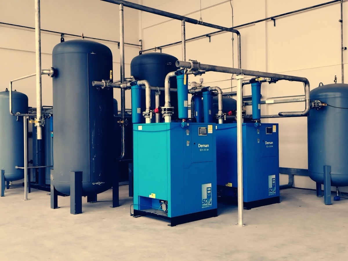 Replacement compressor and pipework being installed in a plant room